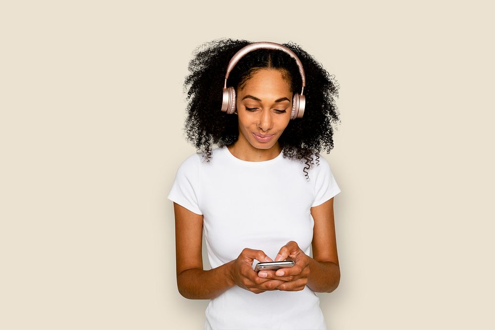 Smiling woman mockup psd texting and listening to music digital device