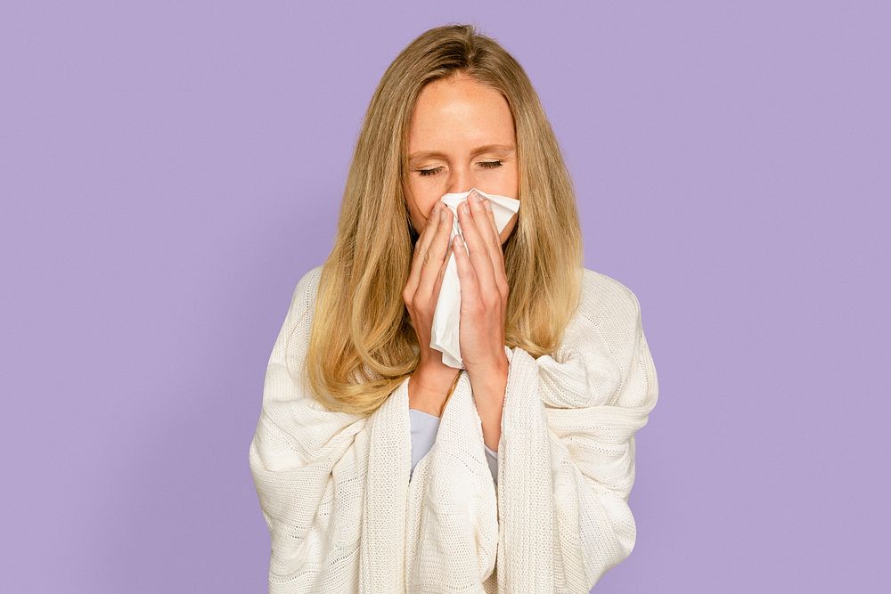 Woman blowing nose mockup psd with blanket covering her