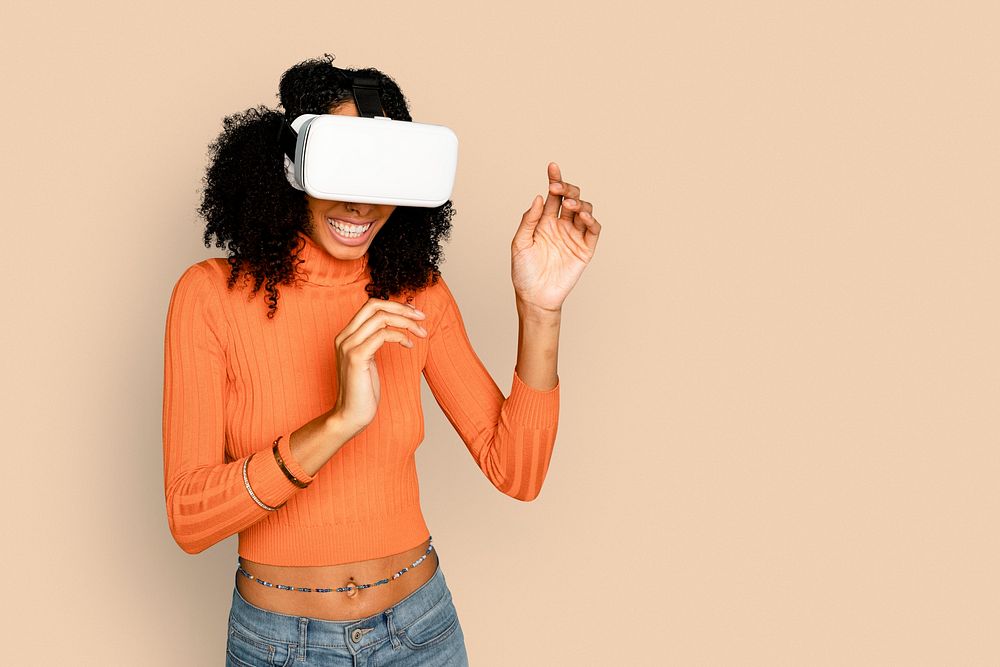 Smiling woman having fun with VR headset digital device