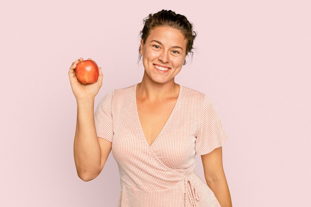 Woman holding apple mockup psd for healthy eating campaign