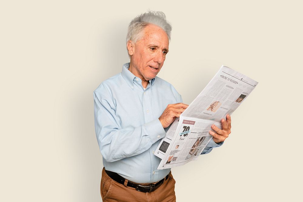 Man reading newspaper on beige background