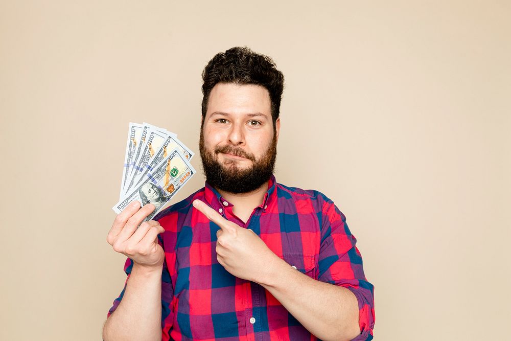 Bearded man holding dollar notes for financial savings campaign