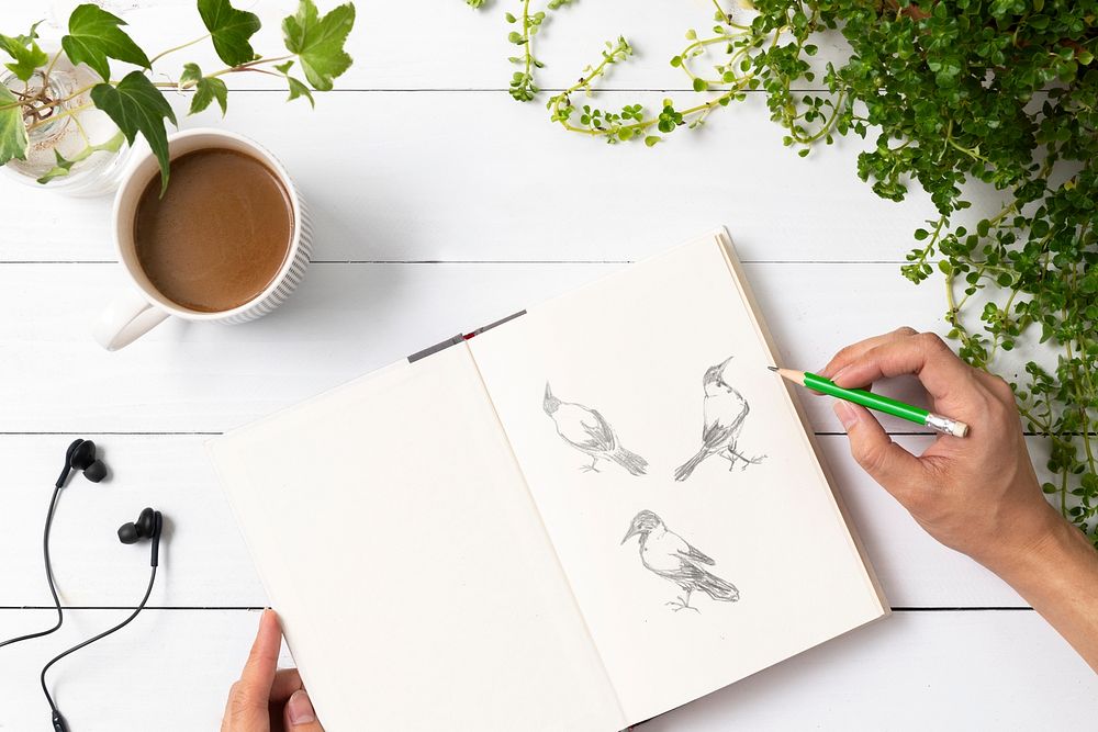 Book mockup psd on wooden table with potted plants flat lay