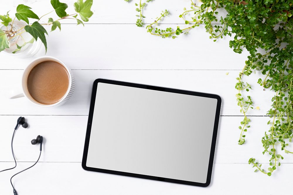 Blank digital tablet screen in houseplants background