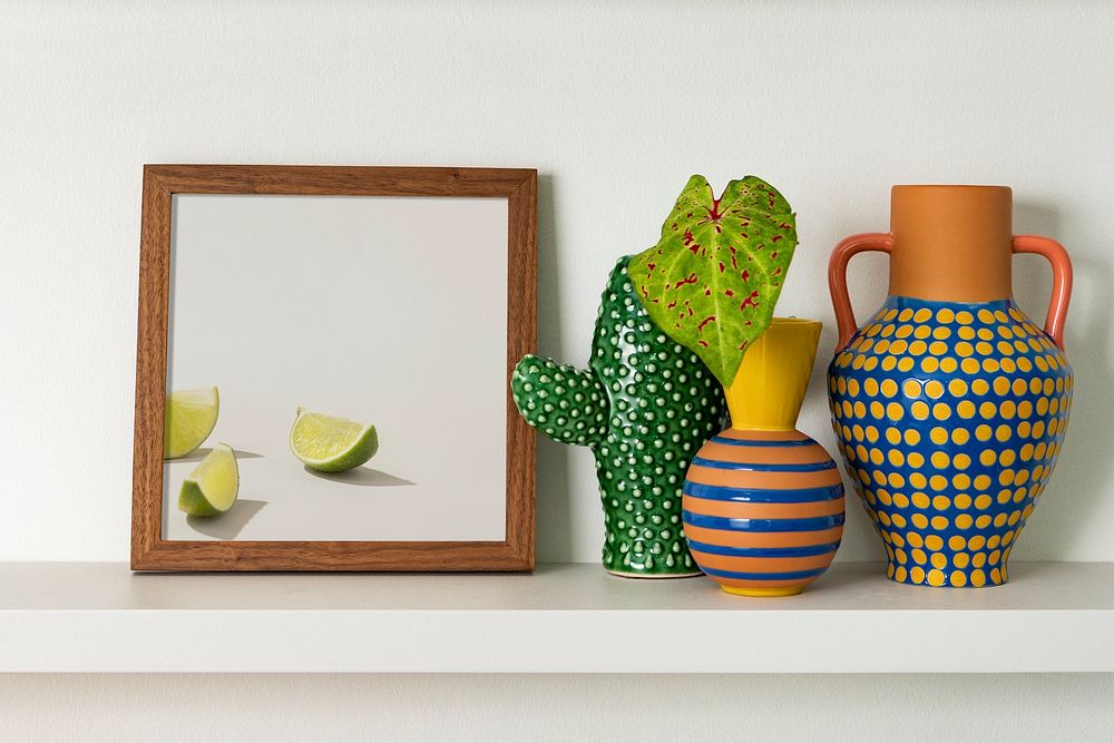 Picture frame mockup psd next to houseplants home decor