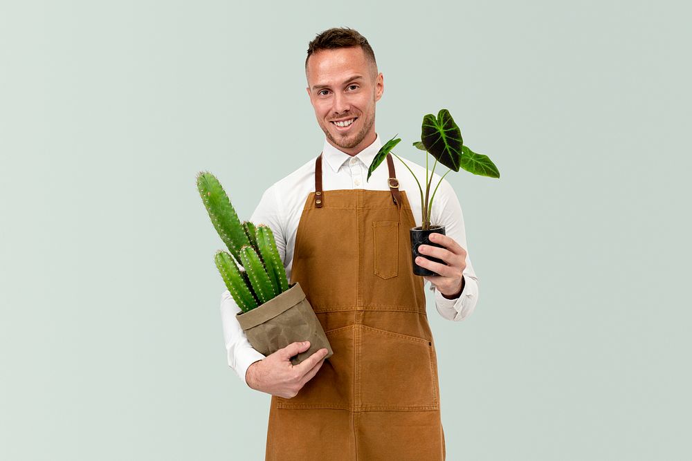 Small business owner holding potted plants