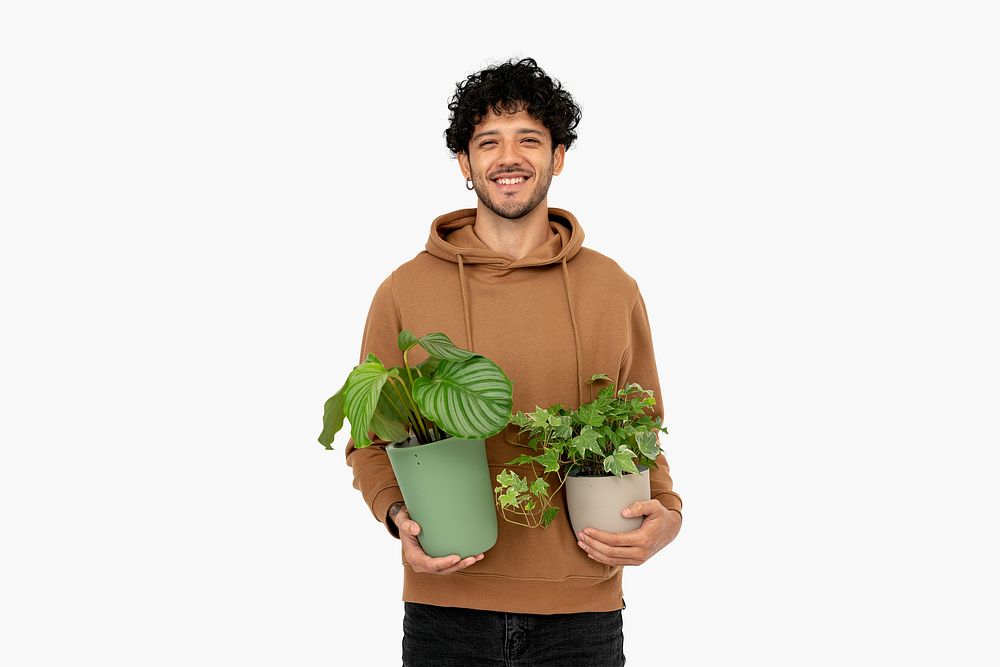 Casual man holding potted houseplant