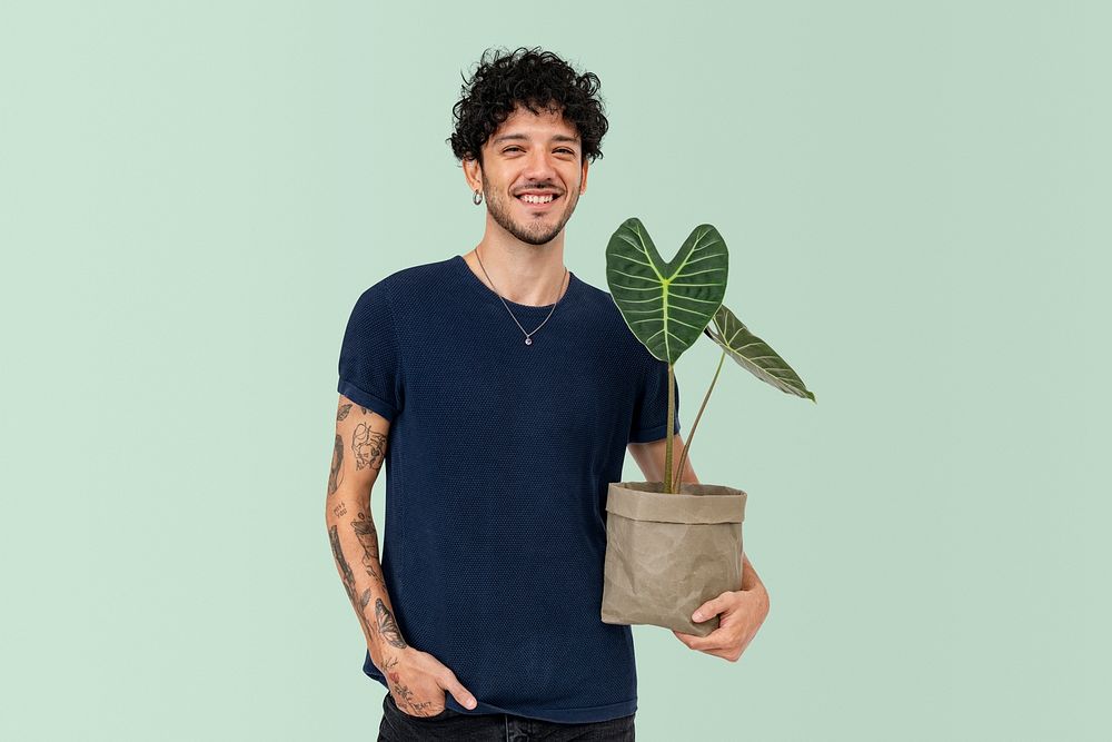 Happy plant parent mockup psd  holding potted alocasia longiloba