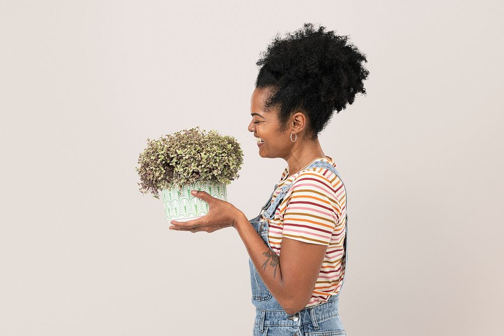 Plant lady mockup psd holding potted shrubs