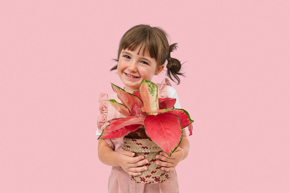 Happy girl mockup psd with potted aglaonema pink lady