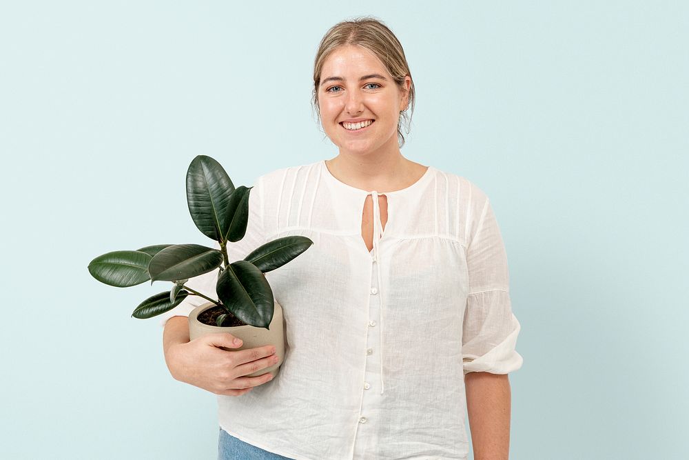 Happy plant lady mockup psd holding potted rubber plant