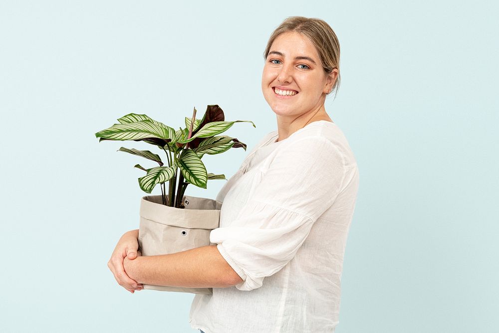 Happy plant lady mockup psd holding potted calathea