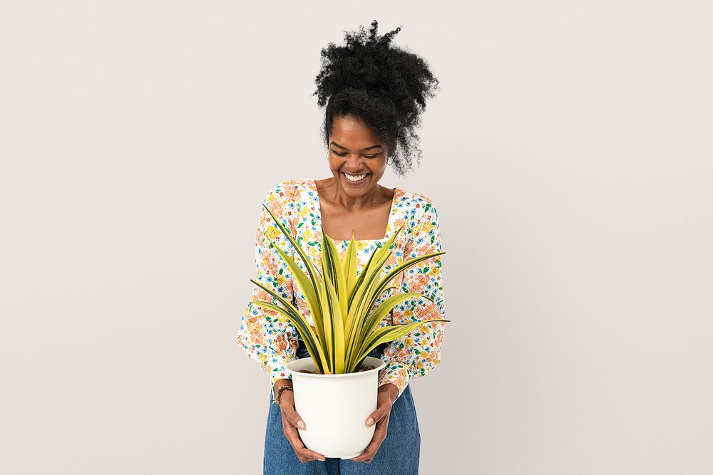 Woman holding a potted spider plant