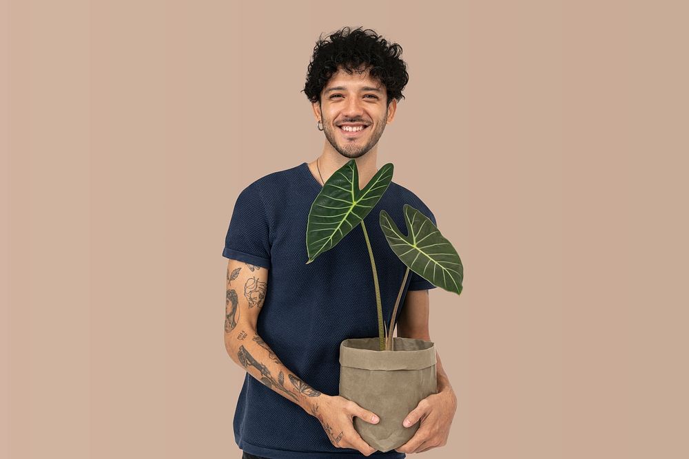 Happy plant lover mockup psd  holding potted alocasia longiloba