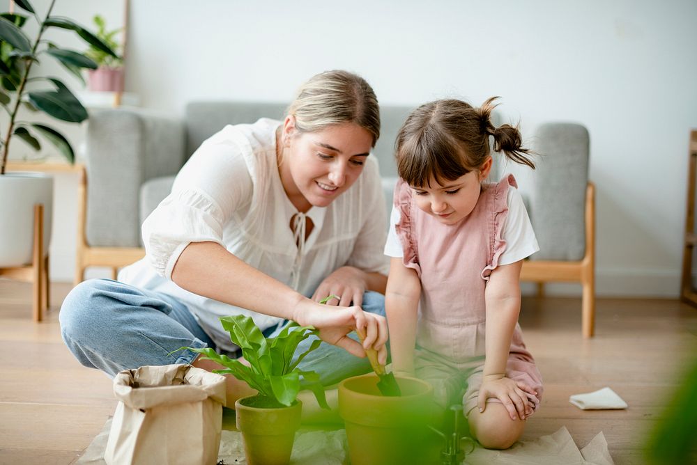 Kid potting plant at home as a hobby