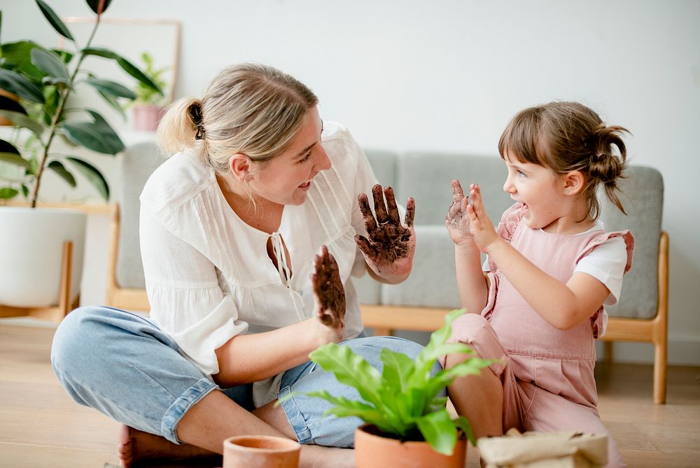 Kid DIY plant potting with mom at home
