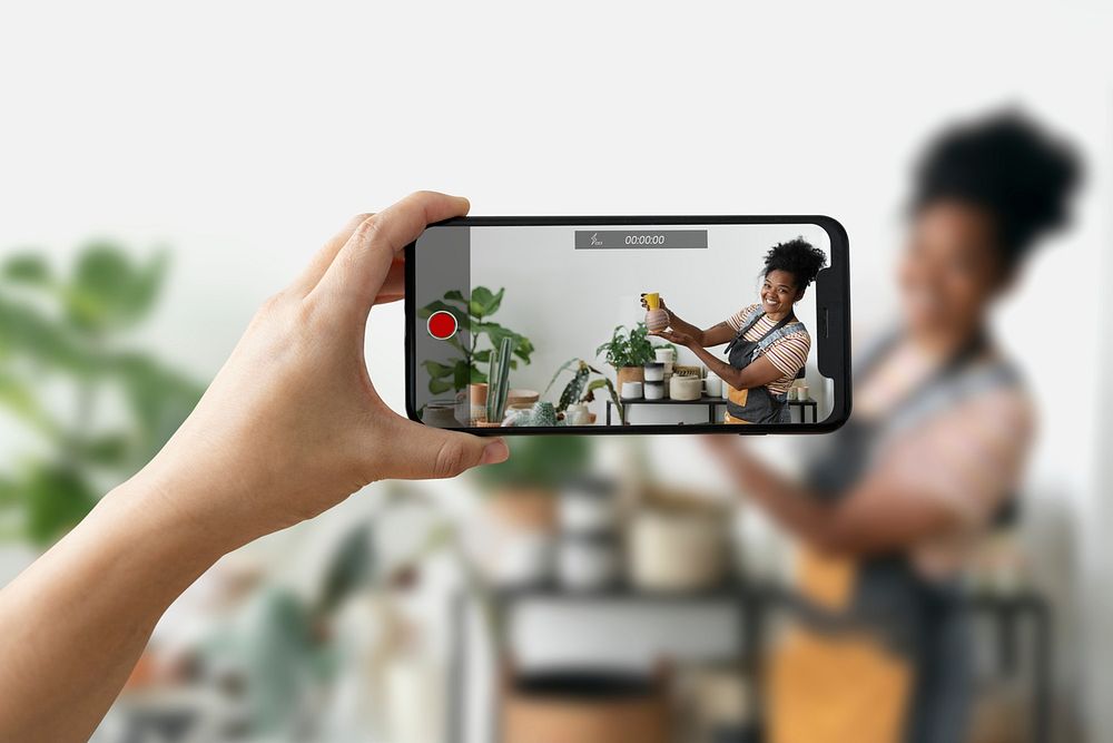 Phone screen mockup psd with plant mother recording a video