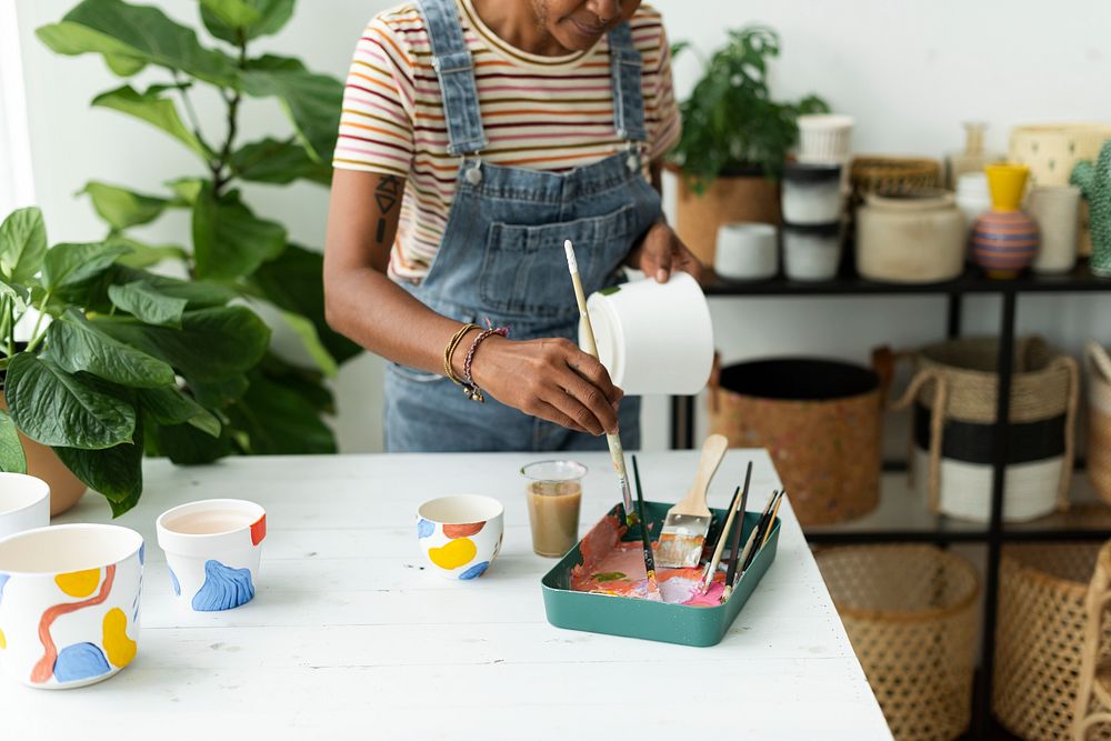 Woman DIY pot painting at a workshop