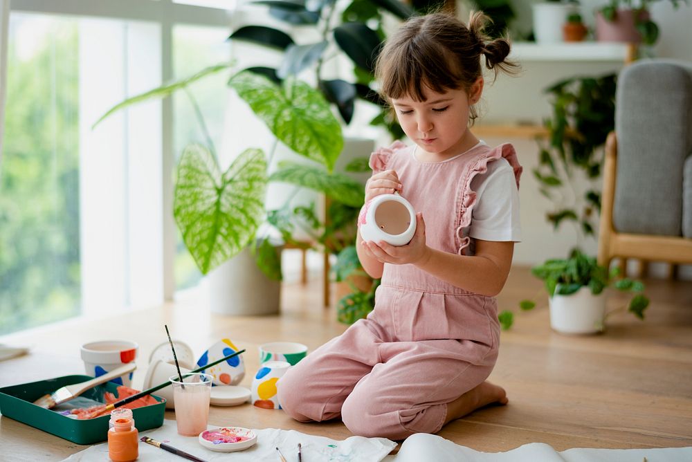 Kid painting a plant pot home diy hobby