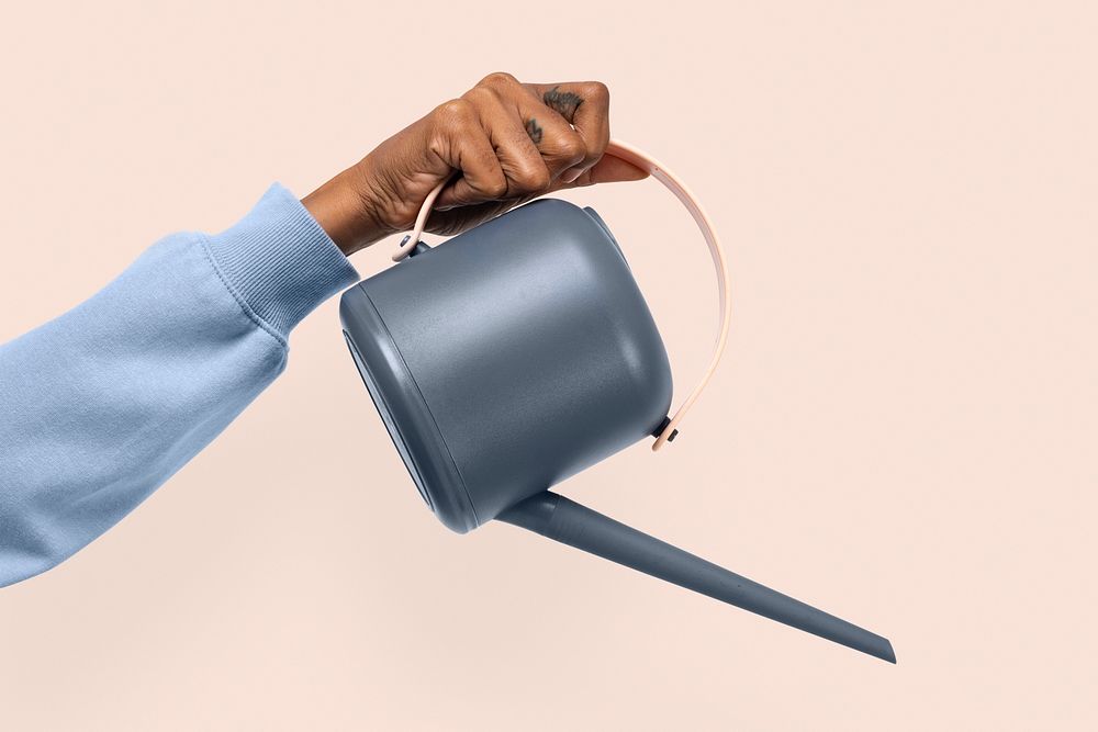 Hand mockup psd holding gray watering can gardening tool