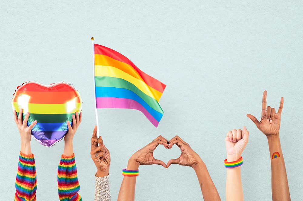 LGBTQ+ pride celebration with hand and crowd cheering