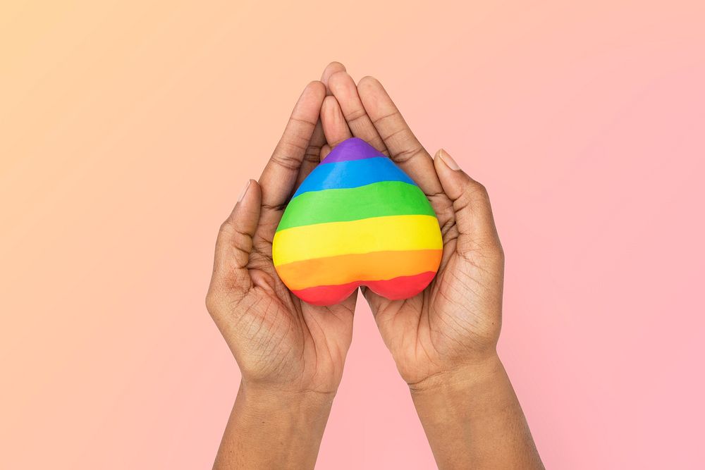 LGBTQ+ community heart with hands presenting