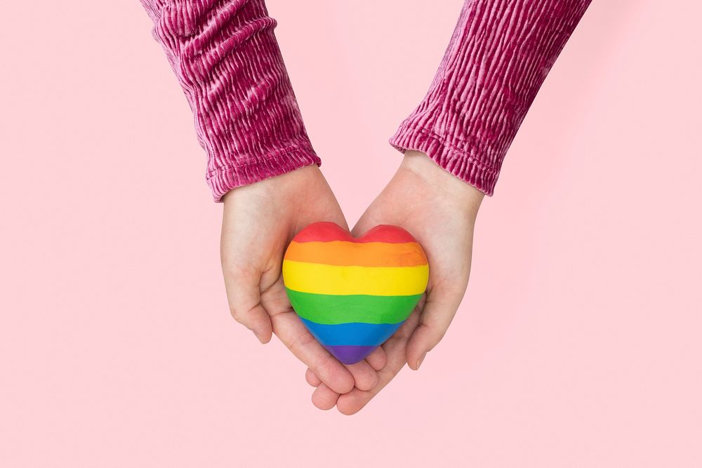 LGBTQ+ community heart with hands presenting