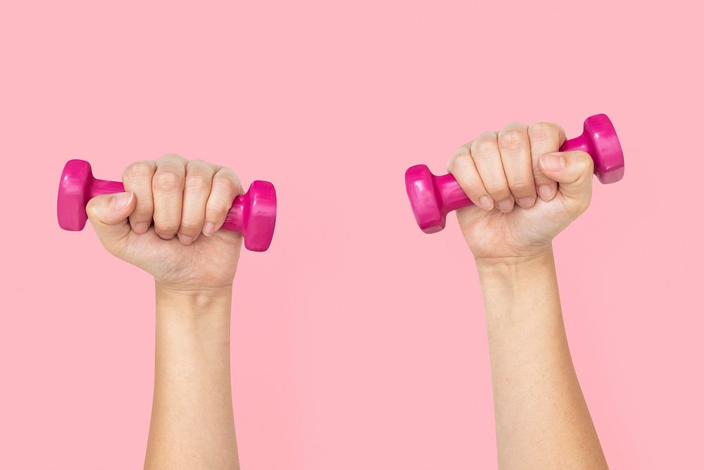 Hand holding dumbbells mockup psd in health and wellness concept