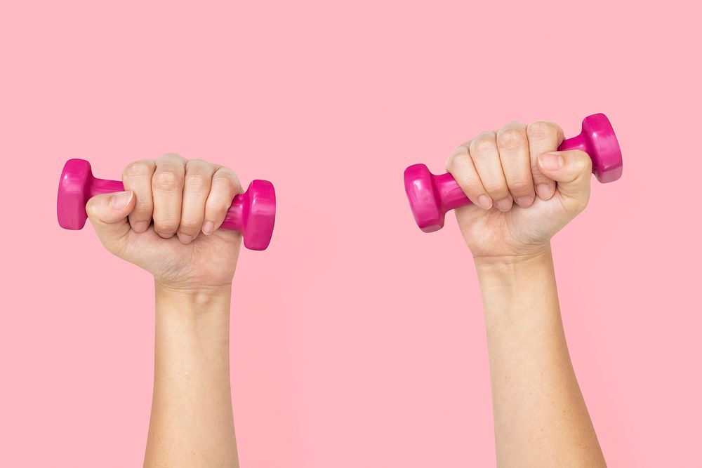 Hand holding dumbbells  in health and wellness concept