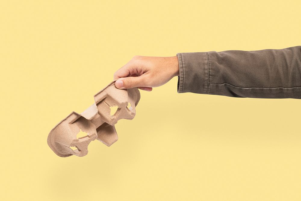 Disposable coffee holder held by a hand for environment campaign