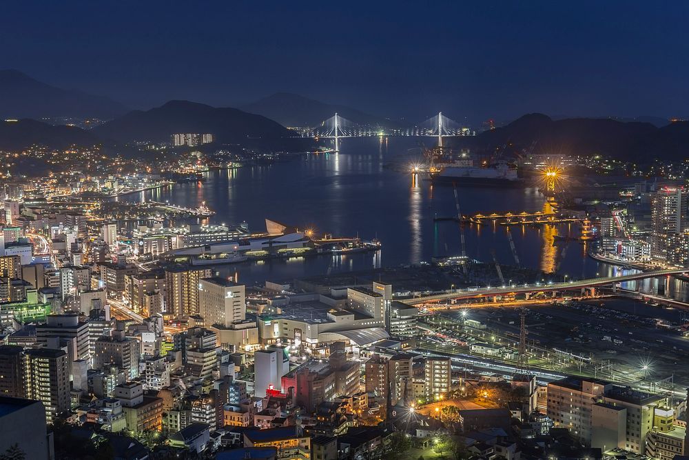 Night cityscape in Nagasaki - view from near the mouth of Urakami River. Original public domain image from Wikimedia Commons