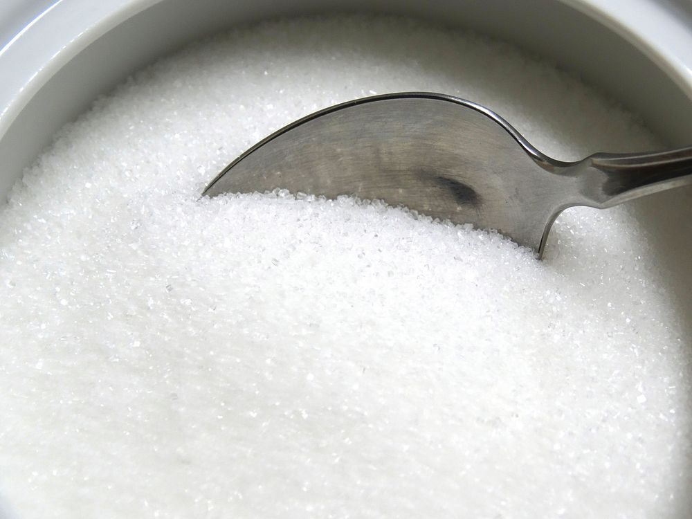 White sugar background. Original public domain image from Wikimedia Commons