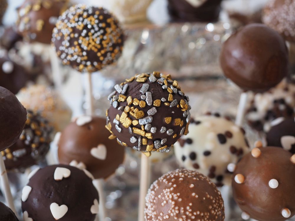 Chocolate cake pop pastries coated with sprinkles. Original public domain image from Wikimedia Commons