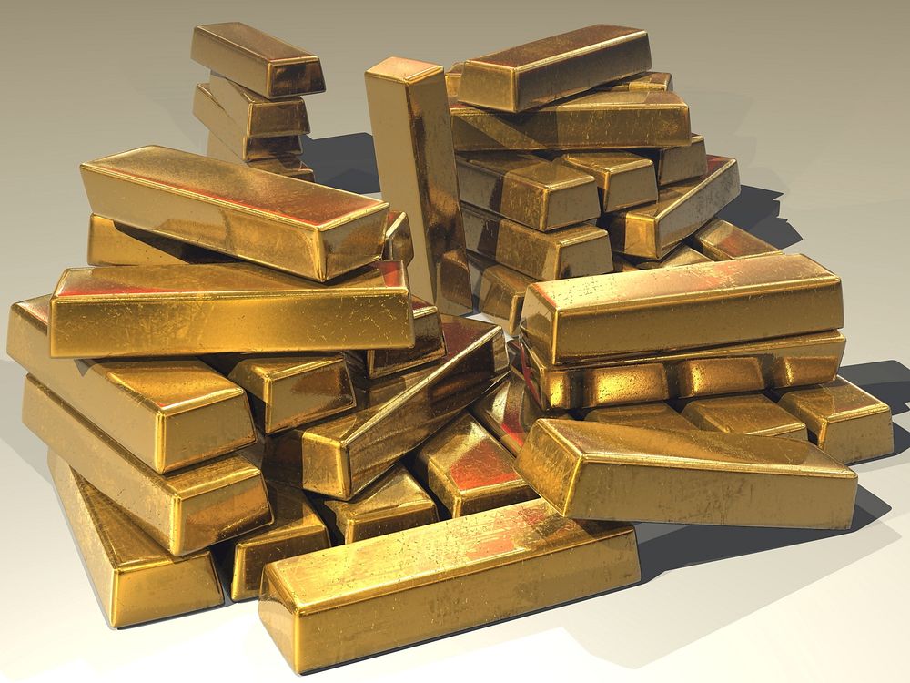 A pile of stacked gold bars. Original public domain image from Wikimedia Commons