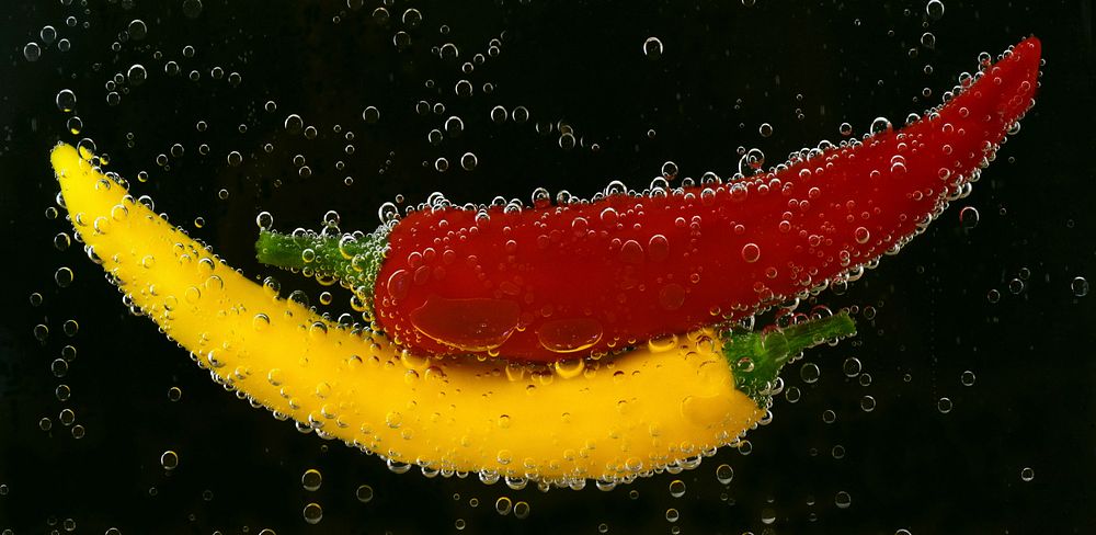Red and yellow bell peppers in water. Original public domain image from Wikimedia Commons