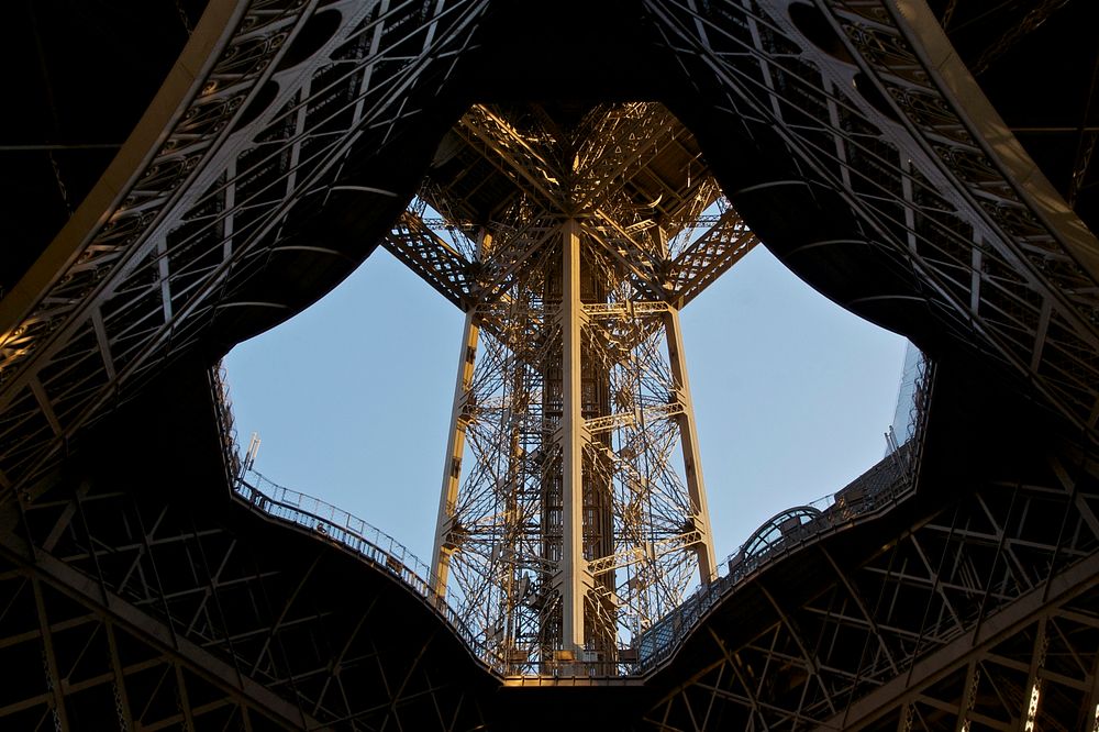 Looking up, through the center, the south pillar of the Eiffel Tower, Paris. Original public domain image from Wikimedia…