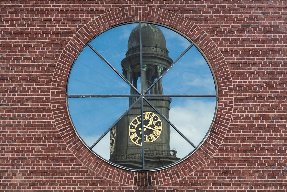 Reflection of St. Michaelis Church in a window of St. Ansgar in Hamburg, Germany. Original public domain image from…