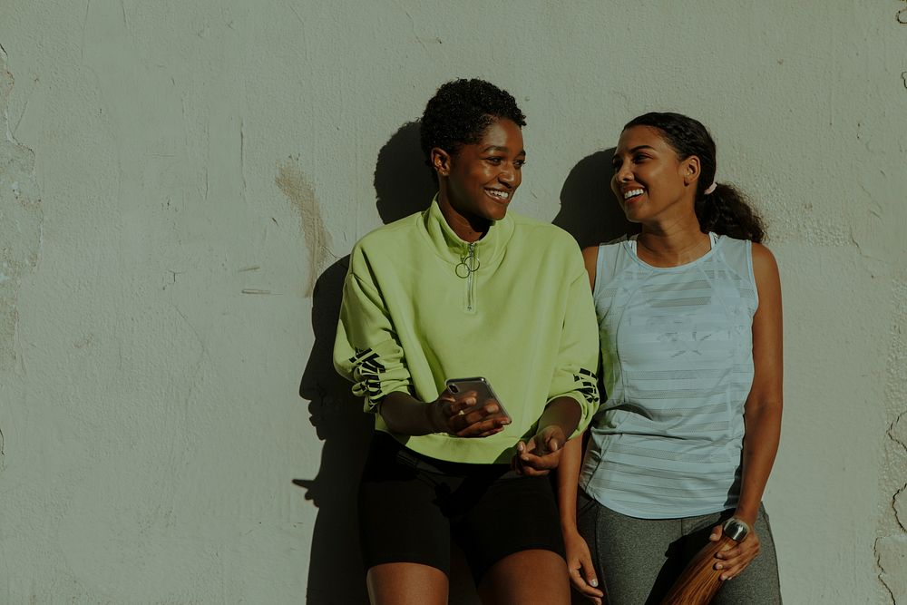 Black women laughing during conversation after workout