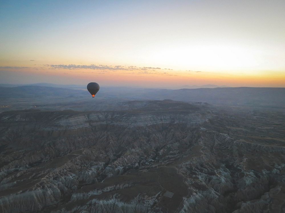 A magical moment, watching the first hot air balloon rise with the sun. Cappadocia, Turkey.
