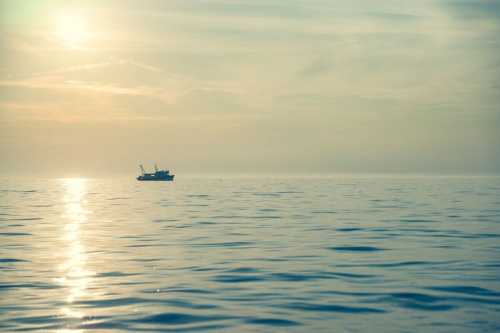 Fishing Boat in Ocean at Sunset.. Original public domain image from Wikimedia Commons