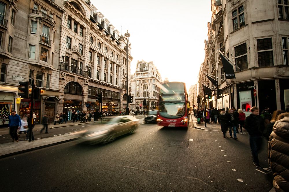 Time lapse shot of busy London street, silver car, red double decker bus pedestrians on sidewalk. Original public domain…