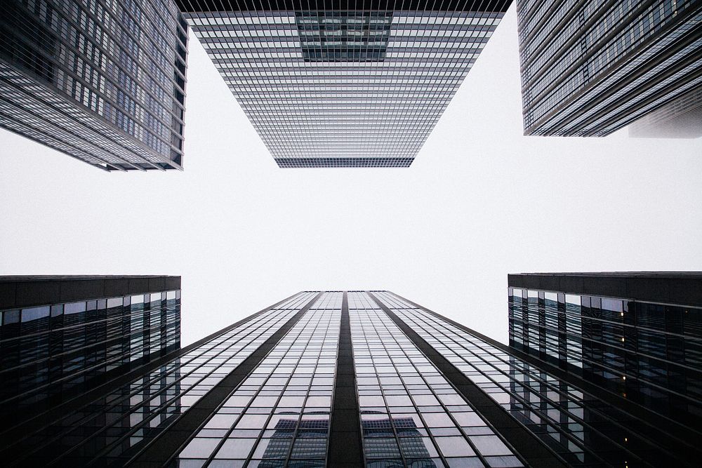 A low-angle shot of tall office buildings on a cloudy day. Original public domain image from Wikimedia Commons