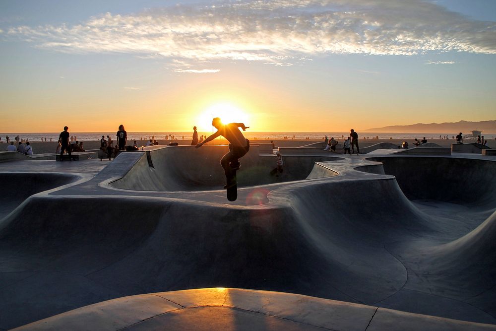 Man skateboarding at the skatepark at Venice Beach and Boardwalk during sunset. Original public domain image from Wikimedia…