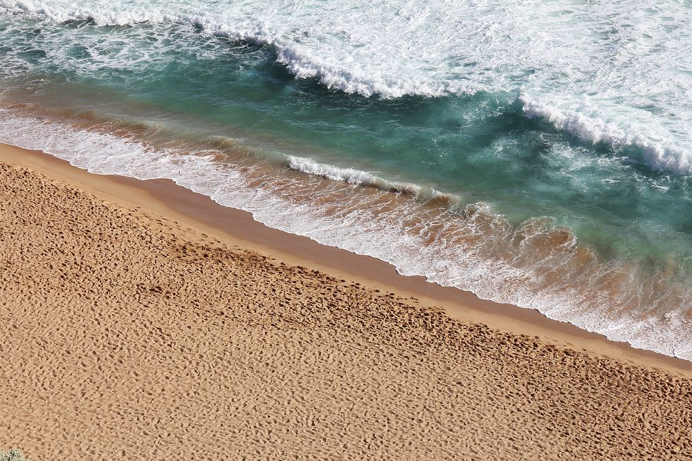Ocean waves washing sandy beach. Original public domain image from Wikimedia Commons
