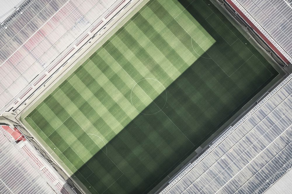 Drone aerial view of a soccer stadium pitch and roof.. Original public domain image from Wikimedia Commons