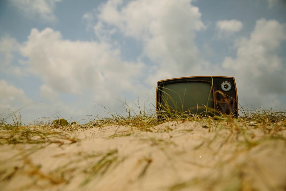 Retro TV on a beach. Original public domain image from Wikimedia Commons