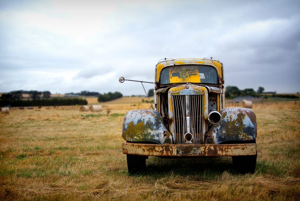 A rusted vintage yellow truck on the Great Ocean Road. Original public domain image from Wikimedia Commons