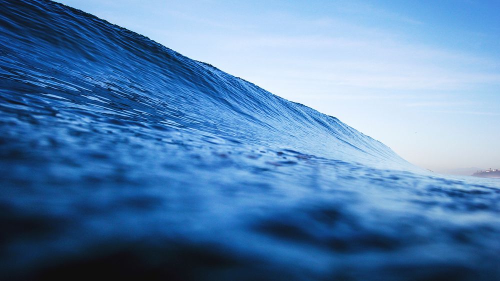 Blue ocean wave viewed from the water surface at Moonlight State Beach. Original public domain image from Wikimedia Commons