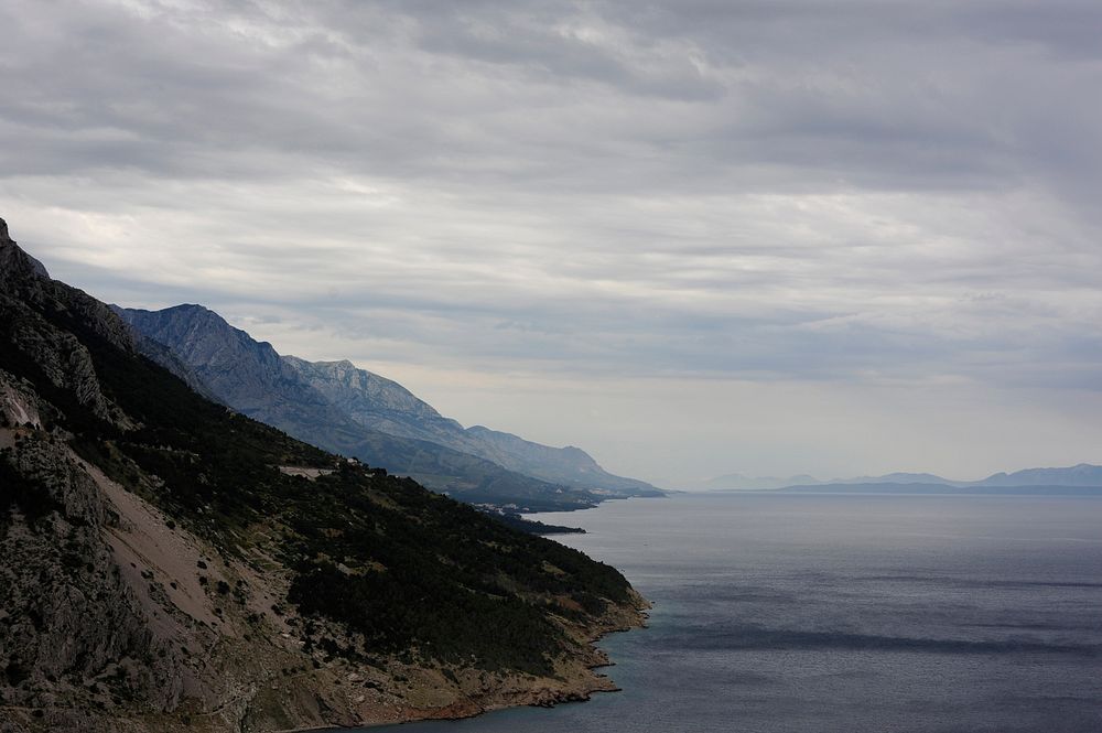 An empty mountainous coast under thick clouds. Original public domain image from Wikimedia Commons