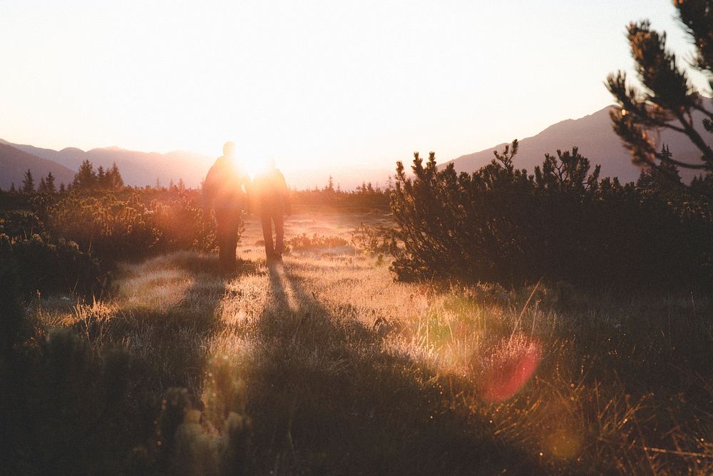 Men walking to the sun on a field. Original public domain image from Wikimedia Commons